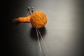 Orange ball of yarn with knitting and needles Royalty Free Stock Photo