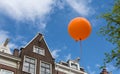 Orange ballon against blue sky in Amsterdam, Netherlands