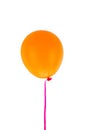 Orange balloon and ribbon flying isolated on white background Royalty Free Stock Photo