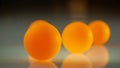 Orange balls on a dark reflective surface