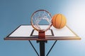 Orange basketball ball falling into the hoop Royalty Free Stock Photo