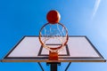 Orange basketball ball falling into the hoop Royalty Free Stock Photo