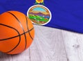 Orange basketball ball with flag Kansas on wooden parquet. Close-up image of basketball ball over floor in the gym. Basketball