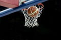 The orange basketball ball flies through the basket Royalty Free Stock Photo