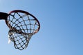 An orange basketball hoop against a blue sky Royalty Free Stock Photo