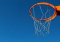 Orange basketball rim and chain metal net against blue sky Royalty Free Stock Photo