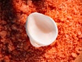 Orange bath salt in a saucer with shells . Copyspace, flatlay. Spa, relaxed, summer Royalty Free Stock Photo