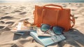 Orange Beach bag on sand at beach with sunglasses and book Royalty Free Stock Photo