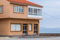 Orange beach house with blue sky near ocean