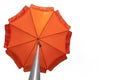 Orange beach umbrella isolated on white. Clipping path included. Copy space Royalty Free Stock Photo