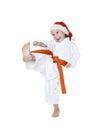 With the orange belt and cap of Santa Claus girl beats a kick leg