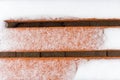 Orange bench covered in snow