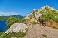 Orange bicycle near rocks by sea Royalty Free Stock Photo