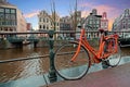 Orange bike along the canals in Amsterdam the Netherlands Royalty Free Stock Photo