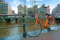 Orange bike along the canals in Amsterdam the Netherlands Royalty Free Stock Photo