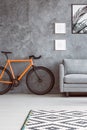 Orange bike next to sofa Royalty Free Stock Photo