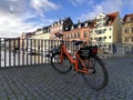 Orange bike parked on a bridge over a channel in the centre of Copenhagen Royalty Free Stock Photo