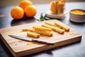 orange biscotti row on wooden board