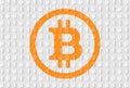 Orange bitcoin sign on gray binary code background