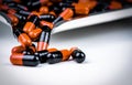 Orange and black capsule pills on drug tray. Antibiotics drug resistance. Global healthcare. Antimicrobial capsule pills. Pharmacy Royalty Free Stock Photo