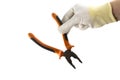 Orange and black flat-nose pliers in the hand in white glove isolated on white background Royalty Free Stock Photo