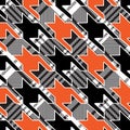 Orange and black houndstooth pattern on plaid background fabric swatch