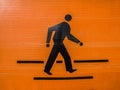 The orange-black pedestrian symbol Royalty Free Stock Photo