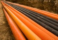 Orange and black plastic pipes