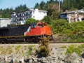Orange and Black Train Engine Going Down Tracks Royalty Free Stock Photo