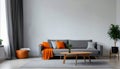 Orange blanket on grey sofa in modern apartment interior with poster and wooden table Royalty Free Stock Photo