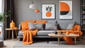 Orange blanket on grey sofa in modern apartment interior with poster and wooden table. Real photo Royalty Free Stock Photo