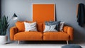 Orange blanket on grey sofa in modern apartment interior with poster and wooden table. Real photo Royalty Free Stock Photo