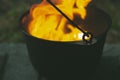 Orange blazing raging fire in a cast iron pot