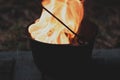 Orange blazing raging fire in a cast iron pot