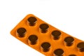 Orange blister pack with pills on white background