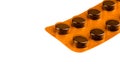 Orange blister pack with pills on white background