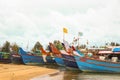 orange and blue fishing boats lined up in a harbor Royalty Free Stock Photo