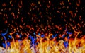 Orange and blue flames, burning, on a black background. Royalty Free Stock Photo