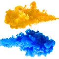Orange and blue ink splashes in the water, isolated Royalty Free Stock Photo