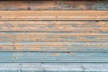 Orange and blue old wooden texture background. Scratched weathered wooden wall with peeled off brown paint Royalty Free Stock Photo
