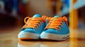 an orange and blue pair of sneakers, with blue laces Royalty Free Stock Photo