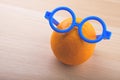 Orange blue plastic glasses wooden table