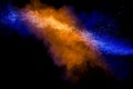 Orange blue  powder explosion on black background.Orange blue color dust splash clouds Royalty Free Stock Photo