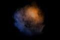 Orange blue  powder explosion on black background.Orange blue color dust splash clouds Royalty Free Stock Photo