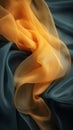 an orange and blue silk fabric is lying on top of a black background Royalty Free Stock Photo