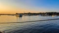 Orange-blue sky transition on the water with picturesque dreamy harbor and small ships with masts. Color transition on the horizon Royalty Free Stock Photo