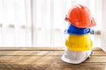 Orange, blue, yellow, white hard safety helmet construction hat Royalty Free Stock Photo