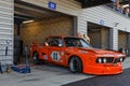 Orange BMW in garage of Grand Prix