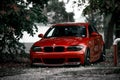 front side of the red tuned and lowered car BMW on the street
