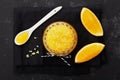 Orange body scrub with sugar and coconut oil in glass jar on black table from above. Homemade cosmetic for peeling and spa care Royalty Free Stock Photo